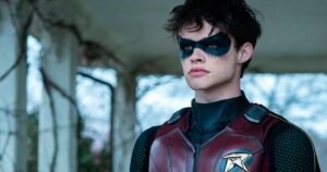 Estrela de Titãs Curran Walters, mostra o logotipo do uniforme de Capuz Vermelho
